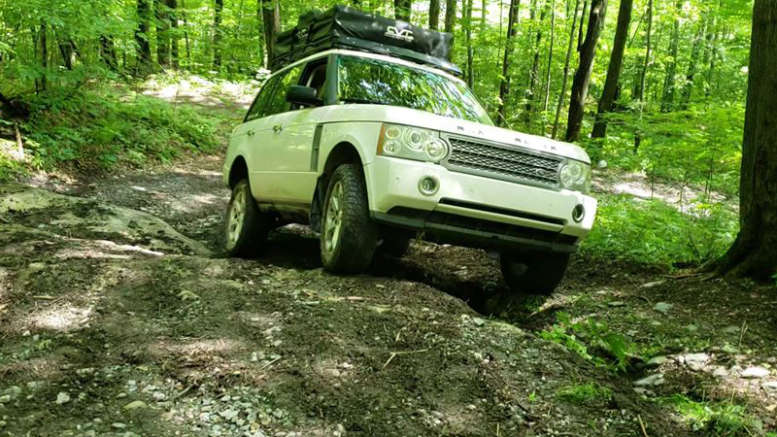 overland range rover with roof top tent